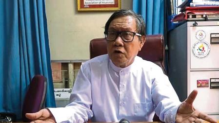 This screengrab provided via AFPTV video footage taken on April 12, 2021 shows Khin Maung Zaw, lawyer for Aung San Suu Kyi who was detained in the February military coup, as he speaks to the media in an office in Naypyidaw. (Photo by AFPTV / AFP)