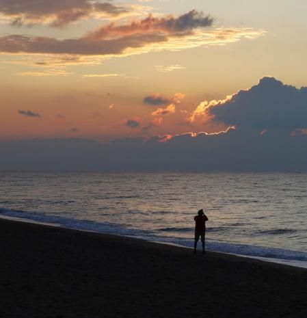 Esperando la salida del sol entre las nubes en la playa de Calella.