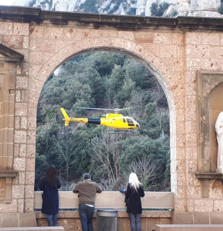 Helicóptero, que realiza el mantenimiento del Cremallera de Montserrat, visto desde las arcadas del Mirador dels Apòstols.