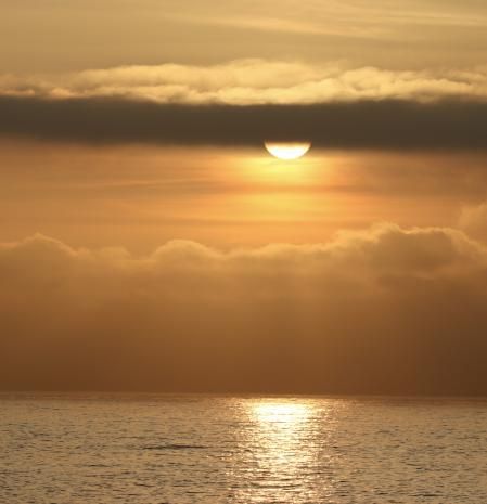 El sol atrapado entre las nubes en Calella de Palafrugell.