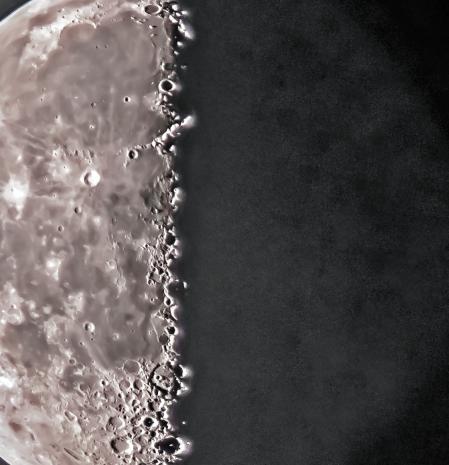 La luna cuarto menguante con la cara oscura y destacando el cráter Copernicus, visto de madrugada en Vic.