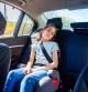 Little girl uncomfortably sleeping in the car without a sleeping pillow