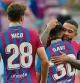 Barcelona's rookie Spanish midfielder Gavi is hugged by Barcelona's Dutch forward Memphis Depay at the end of the Spanish League football match between FC Barcelona and Getafe CF at the Camp Nou stadium in Barcelona on August 29, 2021. (Photo by LLUIS GENE / AFP)