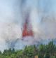 FILE PHOTO: Lava and smoke are seen following the eruption of a volcano in the Cumbre Vieja national park at El Paso, on the Canary Island of La Palma, September 19, 2021. REUTERS/Borja Suarez     TPX IMAGES OF THE DAY/File Photo