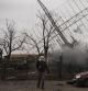 Associated Press videographer Mstyslav Chernov walks amid smoke rising from an air defense base in the aftermath of a Russian strike in Mariupol, Ukraine, Thursday, Feb. 24, 2022. (AP Photo/Evgeniy Maloletka)