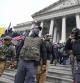 FILE - Members of the Oath Keepers stand on the East Front of the U.S. Capitol on Jan. 6, 2021, in Washington. Federal prosecutors on Monday, Oct. 3, will lay out their case against the founder of the Oath Keepers' extremist group and four associates charged in the most serious case to reach trial yet in the Jan. 6, 2021 U.S. Capitol attack. (AP Photo/Manuel Balce Ceneta, File)