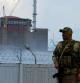 FILE PHOTO: A serviceman with a Russian flag on his uniform stands guard near the Zaporizhzhia Nuclear Power Plant in the course of Ukraine-Russia conflict outside the Russian-controlled city of Enerhodar in the Zaporizhzhia region, Ukraine August 4, 2022. REUTERS/Alexander Ermochenko/File Photo