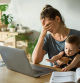 Mother and son sitting at the table with laptop. Mother is consulting online. Looking sad and frustrated.