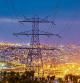 COSTES DE ENERGIA Y SUMINISTROS BÁSICOS.. UNA TORRE DE ELECTRICIDAD CON LA CIUDAD DE BARCELONA DE FONDO