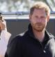 FILE - Prince Harry and Meghan Markle, Duke and Duchess of Sussex visit the track and field event at the Invictus Games in The Hague, Netherlands, Sunday, April 17, 2022. Prince Harry and his wife, Meghan, are expected to vent their grievances against the monarchy when Netflix releases the final episodes of a series about the couple’s decision to step away from royal duties and make a new start in America. (AP Photo/Peter Dejong, File)