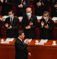 China's President Xi Jinping (bottom) is applauded as he arrives for the second plenary session of the National People's Congress (NPC) at the Great Hall of the People in Beijing on March 7, 2023. (Photo by Greg Baker / AFP)