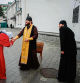 Orthodox priests from the Ukrainian Orthodox Church, accused of maintaining links with Moscow, bless a worshipper during the celebration of the Orthodox Easter in the medieval cave monastery of Kyiv Pechersk Lavra in Kyiv, on April 16, 2023, amid the Russian invasion of Ukraine. (Photo by Dimitar DILKOFF / AFP)