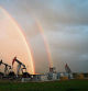 A rainbow appears to come down on pumpjacks drawing out oil and gas from wells near Calgary, Alberta, Monday, Sept. 18, 2023. Canada has the third largest oil reserves in the world and is the world's fourth largest oil producer. (Jeff McIntosh/The Canadian Press via AP)