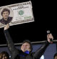 Javier Milei, Liberty Advances coalition presidential candidate, holds a cardboard image of a 100 US dollar bill bedecked with an image of his his face during his closing campaign rally in Cordoba, Argentina, Thursday, Nov. 16, 2023. Milei will face Economy Minister Sergio Massa, the ruling party's candidate, in a runoff election on Nov. 19. (AP Photo/Nicolas Aguilera)