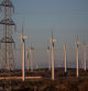 Wind turbines beyond an electricity transmission tower at the Pujalt wind farm, operated by Parque Eolico Pujalt S.L., in the Anoia region of Catalonia, Spain, on Tuesday, Dec. 27, 2022. Spain aims to get almost three-quarters of its electricity from renewables by the end of the decade, up from about 47% last year. Photographer: Angel Garcia/Bloomberg