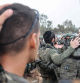 TOPSHOT - Israeli soldiers are briefed as they prepare to go to the Gaza Strip, near the border area in southern Israel on December 13, 2023 amid ongoing battles with the Palestinian Hamas movement. Israel was facing mounting international pressure on December 13 over its war in Gaza, with even key backer the United States criticising the 