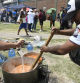 Demonstrators cook for those participating in the protests against the economic reforms of President Javier Milei in La Matanza on the outskirts of Buenos Aires, Argentina, Thursday, Dec. 28, 2023. (AP Photo/Gustavo Garello)