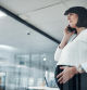 Cropped shot of an attractive pregnant businesswoman standing alone in the office and feeling stressed while using her cellphone
