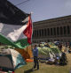A protester holds a Palestinian flag during the Pro-Palestinian demonstration encampment at the Columbia University, Friday, April 26, 2024, in New York. (AP Photo/Yuki Iwamura)