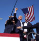 Republican presidential candidate former President Donald Trump is surrounded by U.S. Secret Service agents as he leaves the stage at a campaign rally, Saturday, July 13, 2024, in Butler, Pa. (AP Photo/Evan Vucci)