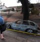 TOPSHOT - A resident leaves with their belongings as the Edgehill Fire destroyed several homes and vehicles during a hot day with temperatures reaching 107 Fahrenheit (41.6 Celsius) in San Bernardino, California, August 5, 2024. A wildfire burned a San Bernardino hillside community (60 miles / 96km east of Los Angeles) on the afternoon of August 5. Initial reports indicated that the fire had grown to at least 100 acres. By 6 p.m., county firefighters reported that the fire was down to 54 acres (22 hectares) and 25% contained. (Photo by DAVID SWANSON / AFP)