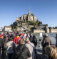 Mont Saint-Michel (Saint Michael's Mount), Normandy, north-western France: tourists crossing the median strip after the spring tide. (Photo by: Andia/Universal Images Group via Getty Images)