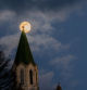 La luna casi llena corona el santuario de Lourdes.