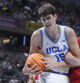 UCLA center Aday Mara (15) pulls down a rebound from Wisconsin forward Nolan Winter (31) during the first half of an NCAA college basketball game in the quarterfinals of the Big Ten Conference tournament in Indianapolis, Friday, March 14, 2025. (AP Photo/Michael Conroy)