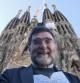 El teólogo Armand Puig posa ante la fachada del Nacimiento del templo de la Sagrada Familia, durante la presentación de su libro "La Sagrada Familia según Gaudí"