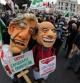 Algunos manifestantes con máscaras de Berlusconi y del líder de la Liga Norte, Umberto Bossi, durante la concentración en Roma