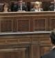 El presidente del Gobierno, Mariano Rajoy (de espaldas), contesta al líder del PSOE, Alfredo Pérez Rubalcaba, durante la sesión de control al Ejecutivo en el Congreso de los Diputados