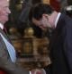 El rey Juan Carlos saluda al presidente del Gobierno, Mariano Rajoy, durante la recepción que ha tenido lugar en el Palacio Real, con motivo de la celebración del Día de la Hispanidad