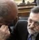 El presidente del Gobierno, Mariano Rajoy (d) y el ministro de Interior, Jorge Fernández Díaz, conversan durante la segunda sesión del debate del estado de la nación que tiene lugar hoy en el Congreso de los Diputados.