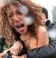Una activista de Femen protesta contra Berlusconi ante el colegio electoral donde este votaba