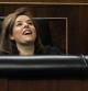 La vicepresidenta del Gobierno, Soraya Sáenz de Santamaría, bromea con unos conocidos de la tribuna de invitados, al inicio del pleno que debate del proyecto de Presupuestos Generales del Estado para 2014, en el Congreso de los Diputados.