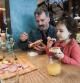 PADOVA, ITALY - FEBRUARY 15:  A child eats with her parents for lunch at a table in the Antonio Ferrari restaurant on February 15, 2017 in Padova, Italy. The restaurant offers a 5% discount off the total food bill if children are well behaved throughout their lunch or dinner.  (Photo by Awakening/Getty Images)