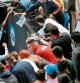 Serbia's Novak Djokovic (L) gives autographs to his fans at the end of group A men's doubles tennis match against Canada's Milos Raonic and Denis Shapovalov on day one of the 2021 ATP Cup in Melbourne on February 2, 2021. (Photo by DAVID GRAY / AFP) / -- IMAGE RESTRICTED TO EDITORIAL USE - STRICTLY NO COMMERCIAL USE --
