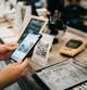 Customer scanning QR code, making a quick and easy contactless payment with her smartphone in a cafe