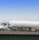 A semi fuel tanker truck hauling a load of gasoline/petrol to local retail gas stations. Shot on an overpass interchange with copy space.
