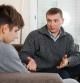 Father soothes teenager son after quarrel