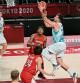 Slovenia's Luka Doncic (C) past Japan's Daiki Tanaka (front L) in the men's preliminary round group C basketball match between Slovenia and Japan during the Tokyo 2020 Olympic Games at the Saitama Super Arena in Saitama on July 29, 2021. (Photo by Aris MESSINIS / AFP)