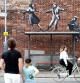 People stop to look at artwork believed to be created by Banksy in Great Yarmouth, Britain, August 8, 2021. REUTERS/Peter Nicholls TPX IMAGES OF THE DAY