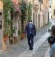 Catalan separatist leader Carles Puigdemont walks in a street of the Sardinian city of Alghero, Italy, Saturday, Sept. 25, 2021, a day after a judge freed him from jail pending a hearing on his extradition to Spain, where the political firebrand is wanted for sedition. (AP Photo/Andrea Rosa)