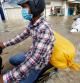 Phnom Penh (Cambodia), 28/10/2021.- People ride their motorbikes in a flooded street at a village on the outskirts of Phnom Penh, Cambodia, 28 October 2021. Thousands of people along Stung Prek Tnaot river in Phnom Penh have been affected by rising flood waters as Cambodia's Ministry of Water Resources issued flood warnings across the country from 27 Oct to 02 November. (Inundaciones, Camboya, Estados Unidos) EFE/EPA/MAK REMISSA
