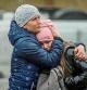 An Ukrainian woman huggs her daughter after acrossing the Ukrainian-Polish border in Korczowa on March 02, 2022. - The number of refugees fleeing the conflict in Ukraine has surged to nearly 875,000, UN figures showed on on March 2, as fighting intensified on day seven of Russia's invasion. (Photo by Wojtek RADWANSKI / AFP)