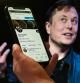 In this photo illustration, a phone screen displays the Twitter account of Elon Musk with a photo of him shown in the background, on April 14, 2022, in Washington, DC. - Tesla chief Elon Musk has launched a hostile takeover bid for Twitter, insisting it was a 