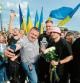 TOPSHOT - The winners of the 2022 Eurovision Song Contest Kalush Orchestra pose for a picture with supporters after their arriving to the Ukraine-Poland border at the crossing point near the village of Krakovets, in Lviv region, on May 16, 2022. (Photo by Sergiy Tys / AFP)