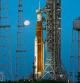 The Strawberry Supermoon sets in front of the NASA Artemis rocket with the Orion spacecraft aboard on pad 39B at the Kennedy Space Center, Wednesday, June 15, 2022, in Cape Canaveral, Fla. Artemis is undergoing tests at the pad before an unmanned mission to the moon. (AP Photo/John Raoux)
