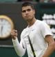Spain's Carlos Alcaraz reacts after winning a point against Germany's Jan-Lennard Struff during their men's singles tennis match on day one of the Wimbledon tennis championships in London, Monday, June 27, 2022. (AP Photo/Alberto Pezzali)