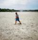 A man walks on Po's dry riverbed as parts of Italy's longest river and largest reservoir of freshwater have dried up due to the worst drought in the last 70 years, in Boretto, Italy, June 22, 2022. REUTERS/Guglielmo Mangiapane